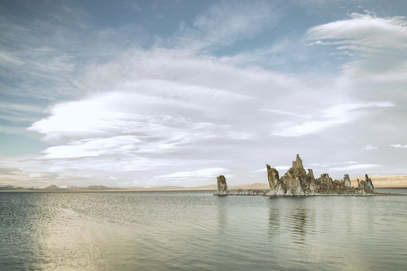 Tufa towers standing in the still water of Mono Lake under a wide sky